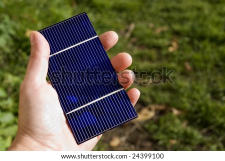 solar hand in a hand,green grass in background