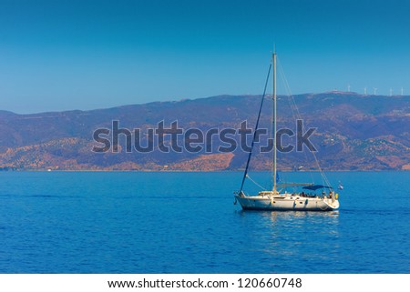 Yacht sailing away from Greek Island