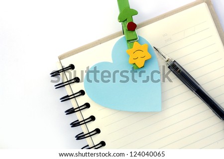Note book and a pen on white background