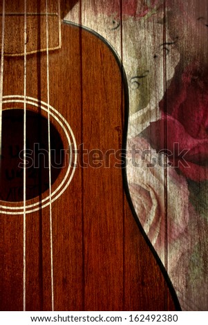 Ukulele fretboard, a part of ukulele hawaiian  guitar with wooden background,art background