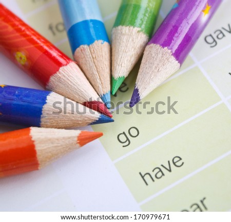 color pencils with inspiration motivation words on paper background
