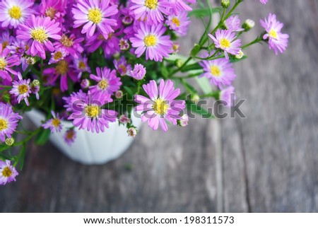 Purple flowers, sweet purple flowers on an old wood background.