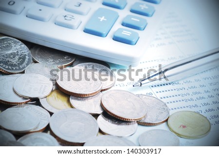 pen and coins on bank account
