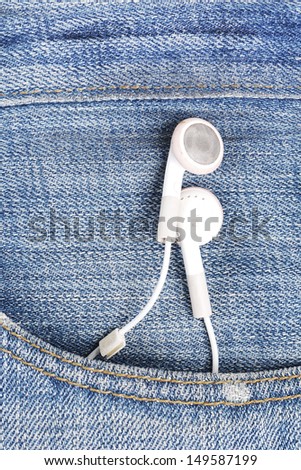 white earphone hanging out from jeans pocket