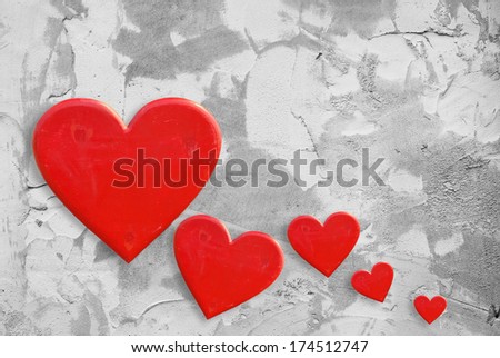 Red hearts on grunge cement wall background
