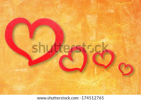 Red hearts on grunge yellow wall background