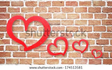Red hearts on grunge brick wall background