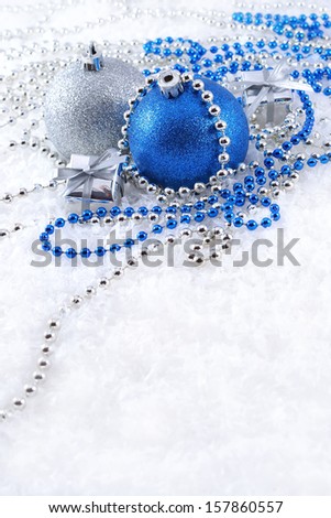 Silver and blue Christmas decorations on a white background