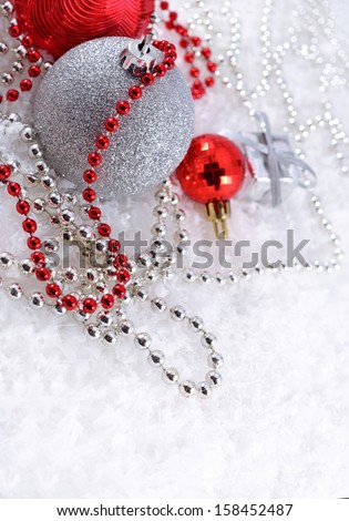 Silver and red Christmas decorations on a white background