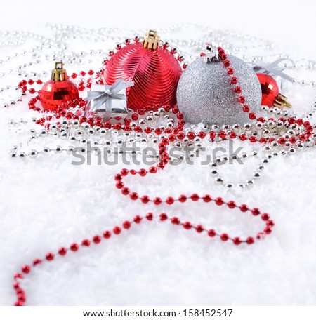 Silver and red Christmas decorations on a white background