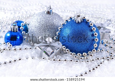 Silver and blue Christmas decorations on a white background