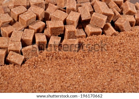 Brown granulated and refined sugar as background texture