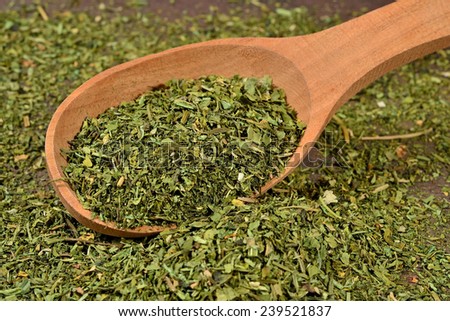 Dried parsley in a wooden spoon