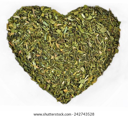 Dried parsley in the form of heart on a white background