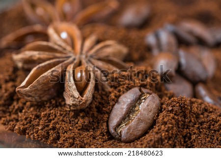 Close-up of anise and  coffee beans with roasted coffee heap.  Arabic roasted coffee with spices.