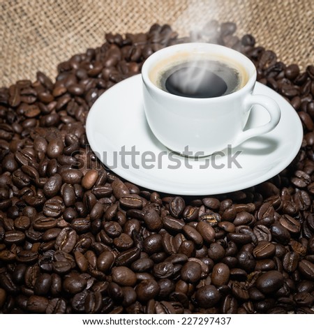 cappuccino with  smoke and roasted coffee beans