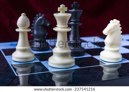 chess pieces. Black and white chess pieces on blue board