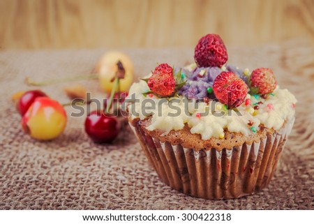 Strawberry  cupcake on wooden background.
