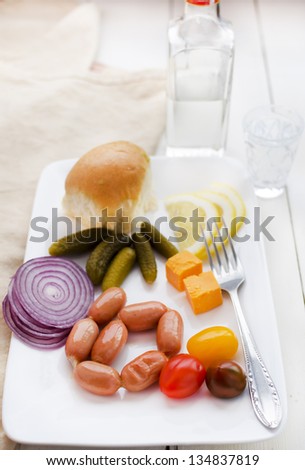 Vodka Served: grilled turkey sausages, red onion sliced, pickled gherkins, sliced lemon, Ukrainian traditional garlic bun \