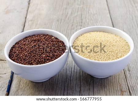 Red Quinoa And Amaranth In White Bowls On The Vintage Wooden Table