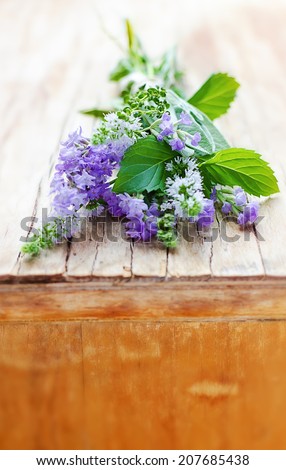 Bunch of aromatic herbs on the vintage wooden cupboard: lavender, mint, thyme, sage