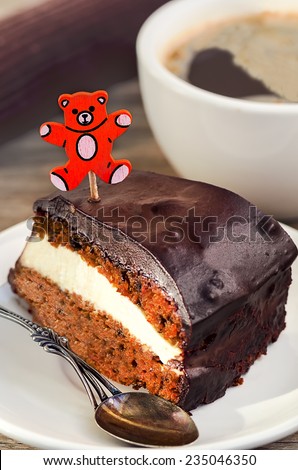 Carrot cake with coffee and teddy bear pick