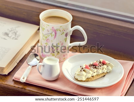 Breakfast with coffee, milk and cake with hearts served on the windowsill, toned