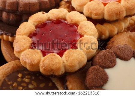 some  biscuits with different fillings, focus on the one with strawberry jelly