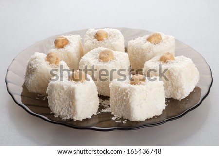 coconut cakes on a brown glass plate