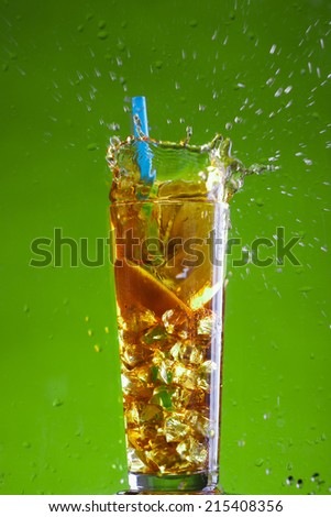 ice tea splash on green background