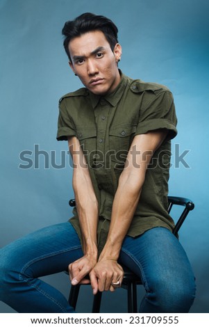 a studio portrait of a young asian male model in stylish casual clothes