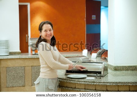 Woman with plate at hotel buffet