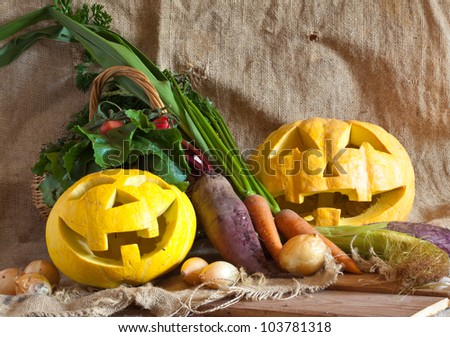 Halloween pumpkin and harvested vegetables on sacking