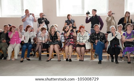 VLADIMIR, RUSSIA - MAY 24: \'Last Bell\' event. May 24, 2012 in Vladimir, Russia. School leavers celebrate the \'Day of Farewell Bell\'  in school Ã?Â¹ 33. Parents and friends looking the ceremony
