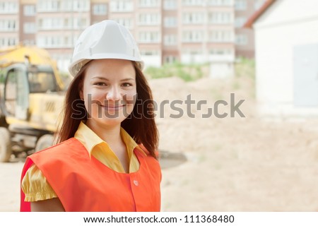 happy builder in hardhat works on the building site
