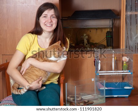 Happy woman with  pets in home