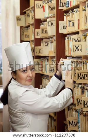 Female doctor searching for patient\'s records in clinic