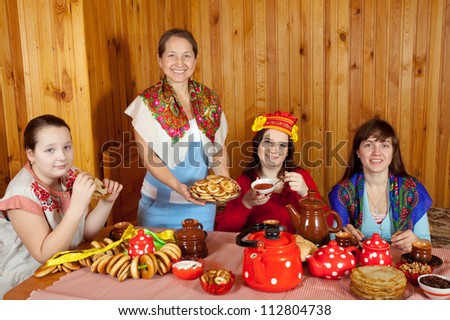 Women  drinks tea and eats pancakes  in home