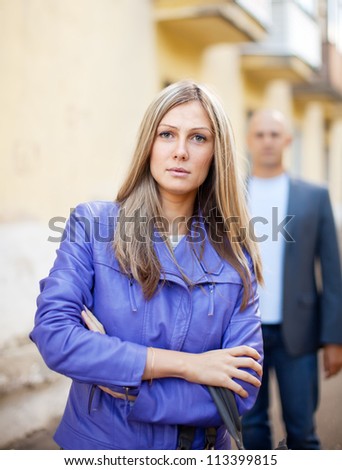 Man walks behind woman on the city street
