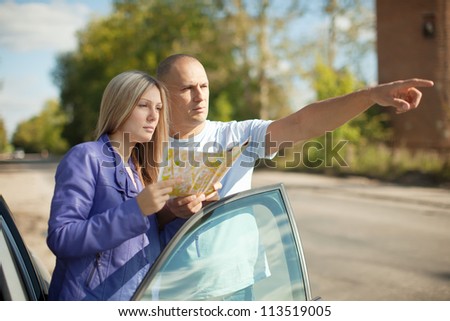 man points the direction at the road