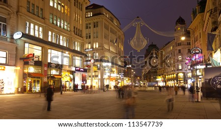 VIENNA, AUSTRIA - NOVEMBER 22: Tourists and locals walking at Main Square of  Vienna in night on November 22, 2011 in Vienna, Austria. Vienna Main Street Square - the most beautiful street in the city