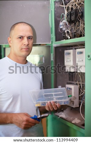 Man working with electrical shield at house