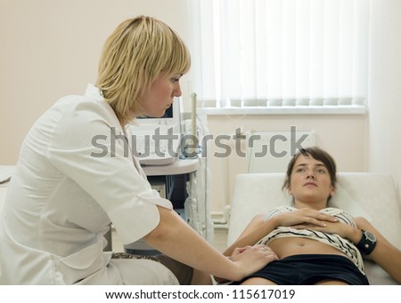 Female patient laying down on couch during medical examination