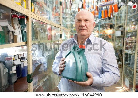man buys automobile chemicals in the auto parts store