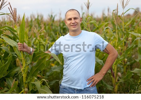 man standing in field of corn