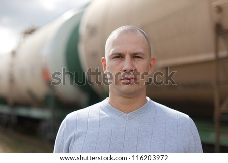 worker near oil cistern car at railway