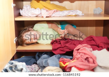 Baby girl is in the closet at home