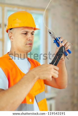 Man works with electrical wires in the new house