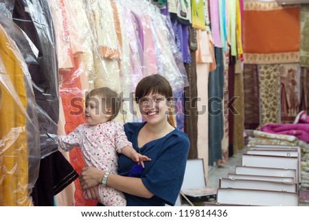 Family  chooses clothes at fashionable shop