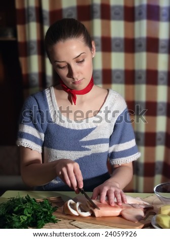 Slicing of boiled calamar on a cook-table